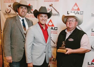 Lars DeLeeuw is presented with an LMAC Bronze sponsored by the Canadian Angus Association.