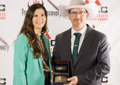 Reserve Champion, Tyler Slawinski from Gladstone Auction Mart and Ashern Auction Mart, receives the Canadian Shorthorn Association Buckle from the Canadian Shorthorn Manager, Shayla Chappelle.