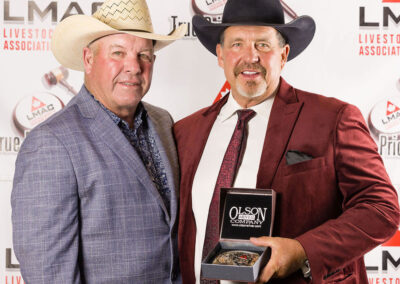1st Runner Up, Rob Bergevin, from Foothills Auctioneers Inc. at Stavely, Alberta, receives the Canadian Charolais Association Buckle from Charolais Rep. John Meilhausen.