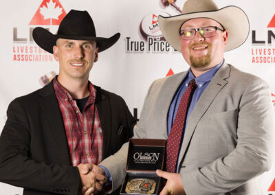 3rd Runner Up, John Baier from Heartland Livestock in Swift Current, Saskatchewan won the Canadian Angus Association Buckle presented by Manitoba Angus Association President Devin Boiston.
