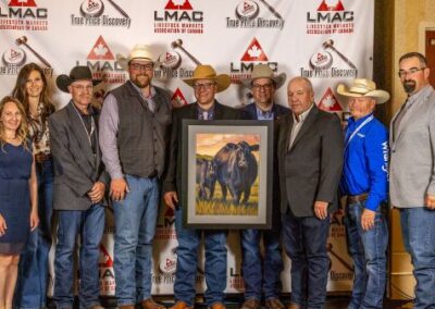 Allan Lively and Ryan Konynenbelt, along with market manager Tyler Cronkhite from S.A.L.E. Cowtown Livestock Exchange, received the All-Breeds presentation to the host auction market of the LMAC Canadian Livestock Auctioneering Championship.