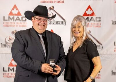 LMAC Champion Auctioneer receives the custom-made Championship Ring from Sharon Bergevin of Foothills Auctioneers Inc. in Stavely, Alberta.