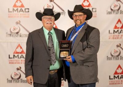 The Bob Wright Memorial Man/Sask Rookie of the Year buckle is sponsored by Rick Wright Cattle Consulting. Rick Wright is presenting the buckle to 2026 winner Johnaton Stratuliak from the Killarney Auction Mart.
