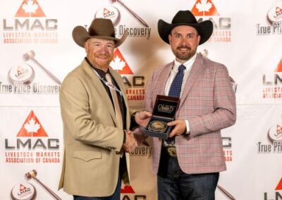 Brennin Jack from Jack Auction Group in Virden, MB, sponsors the Most Improved Auctioneer. This year’s winner is Josh Poland from the Olds Auction Mart in Olds, AB. Brennin Jack is making the presentation.