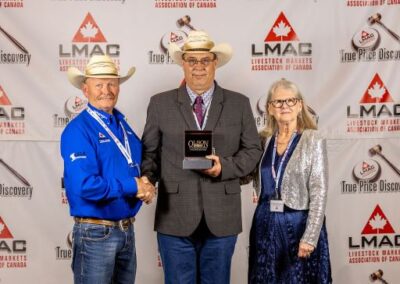 2nd-place runner-up Kyle Soderberg from Northern Livestock Sales in Lloydminster, Sask., received the Canadian Angus Association Buckle from Bob Miller, President of B.C. Angus and Lynanne Good.